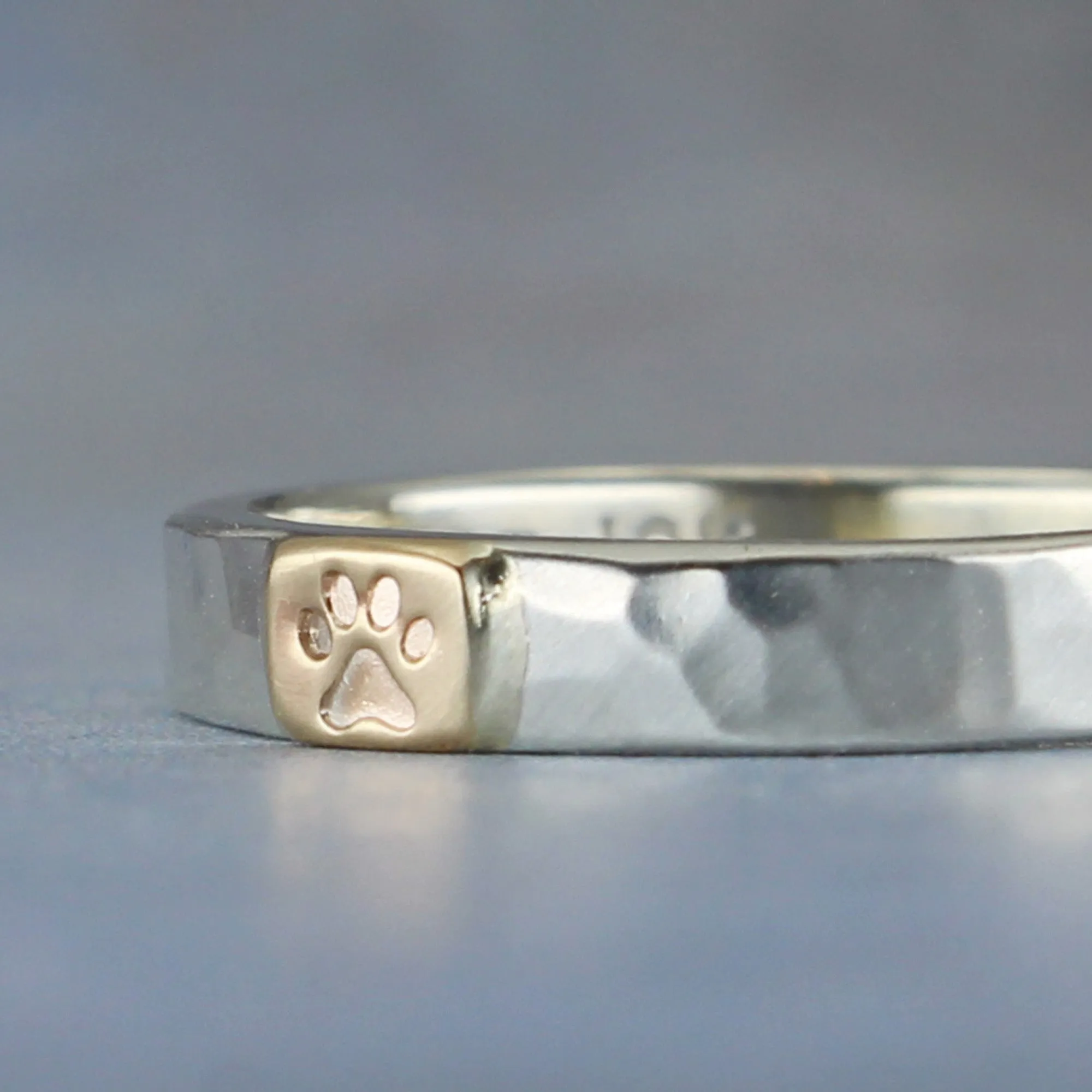 Stackable sterling silver ring with paw symbol on 10k gold tab